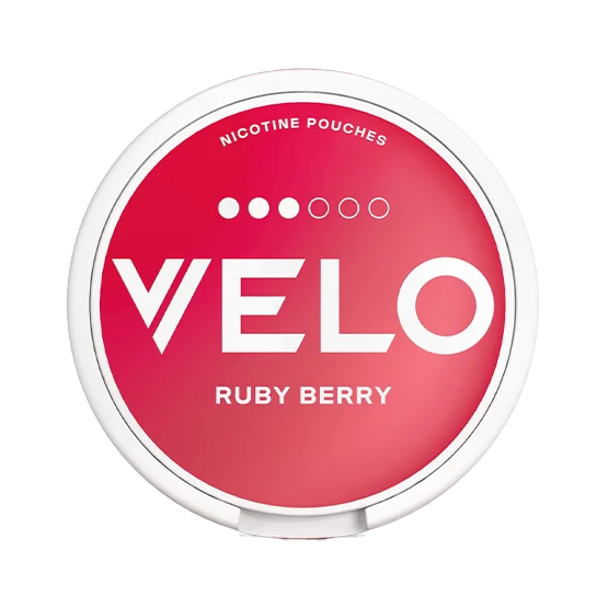 A round white container of VELO Ruby Berry nicotine pouches, featuring a vibrant red label with white text and a five-dot strength indicator.